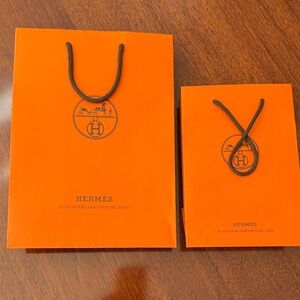 Hermès Vibrant Orange Bags with Black Accents and ribbon